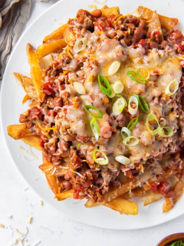 overhead image of chili cheese fries on a white plate