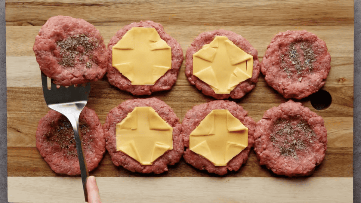 cheese slices on top of burger patties.
