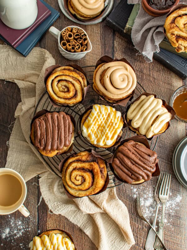 platter of bakery style cinnamon rolls, some with icing.