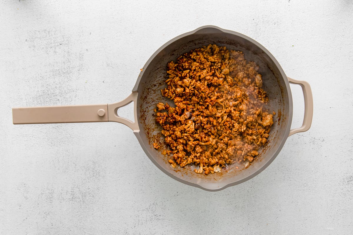 ground chicken with pf changs lettuce wrap sauce in a frying pan.