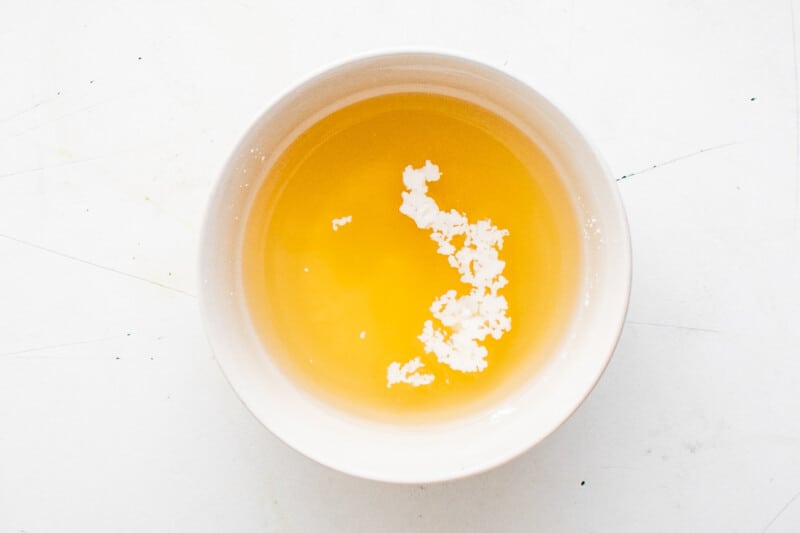 chicken broth and cornstarch in a small white bowl.