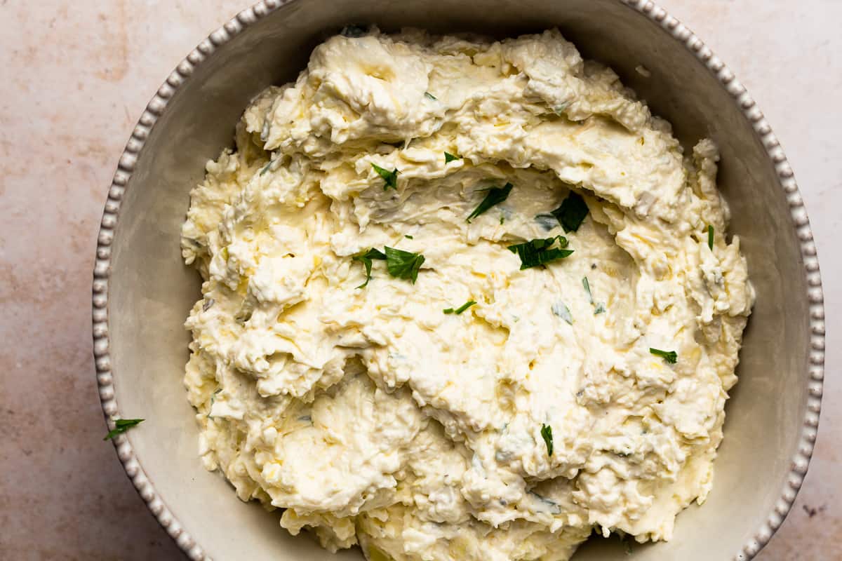 bowl of cream cheese artichoke dip.