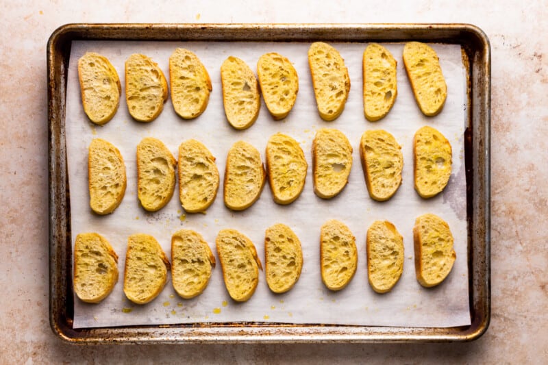 slices of bread lined up on a baking tray