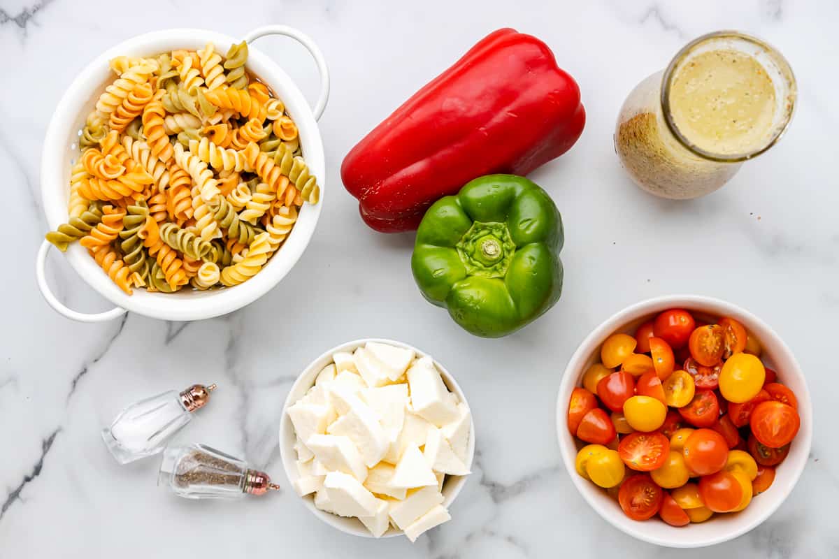 overhead view of ingredients for tricolor pasta salad.