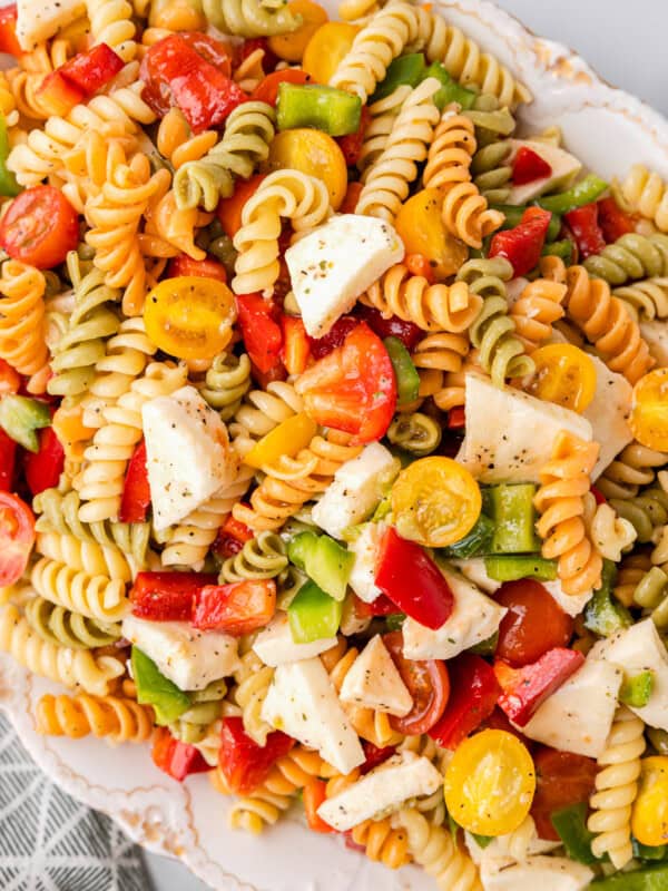 tricolor pasta salad in a white serving bowl.