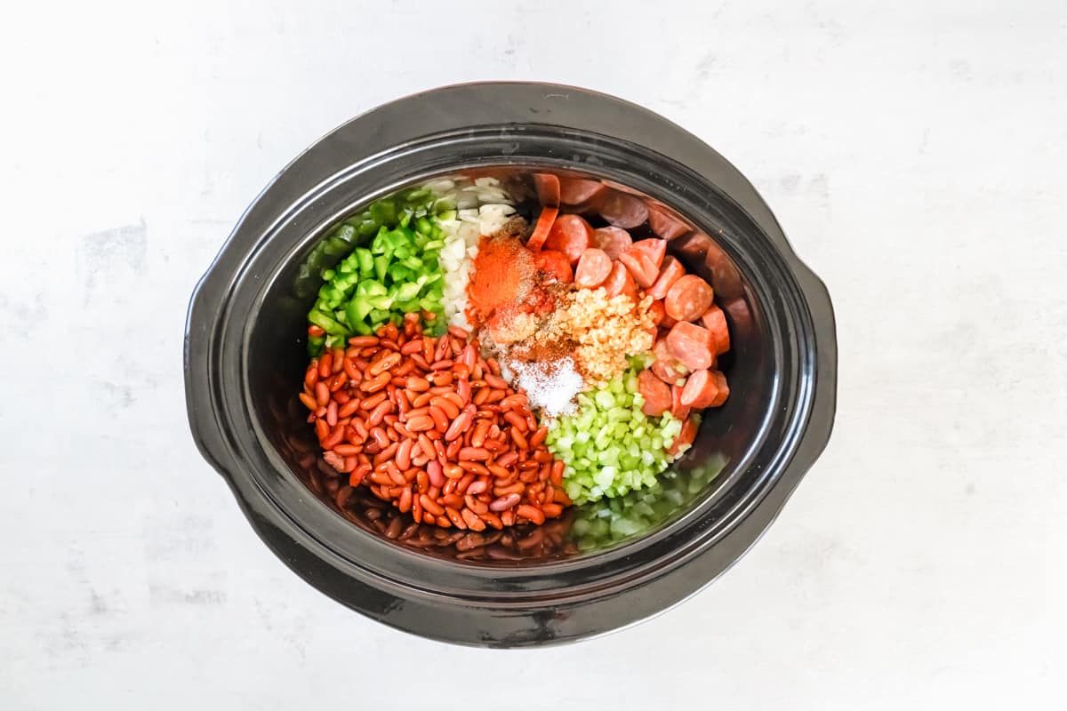 ingredients for red beans and rice in a crockpot.