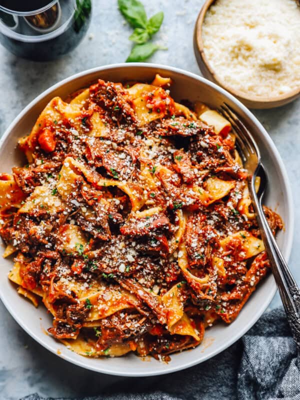 beef ragu in a white bowl with a fork.