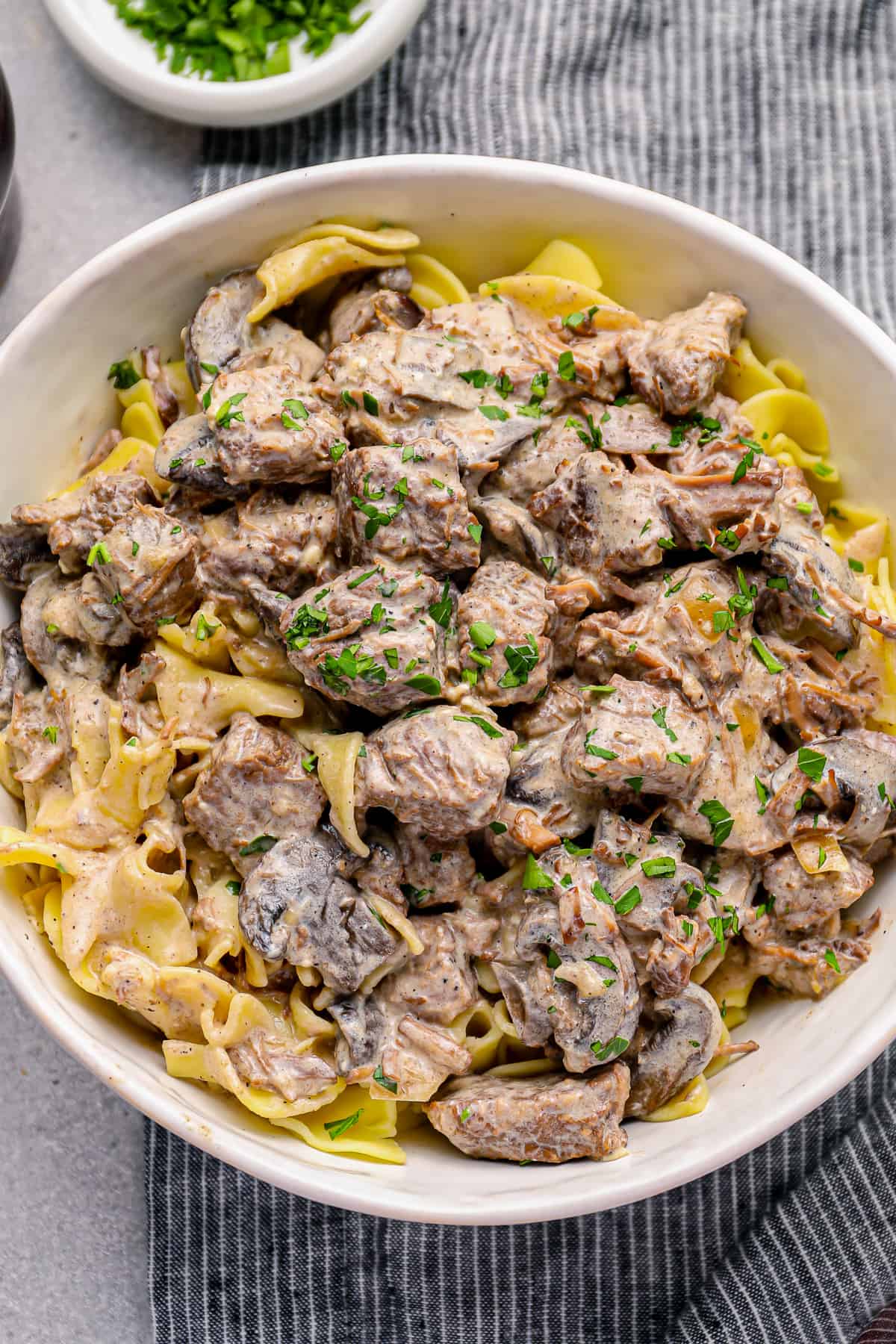 crockpot beef stroganoff in a white bowl.