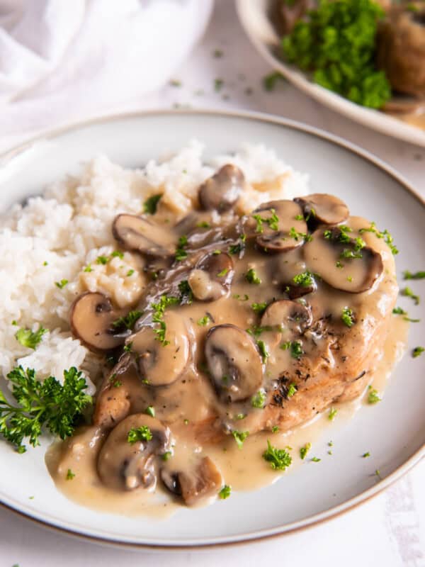 crockpot chicken marsala with white rice on a white plate.