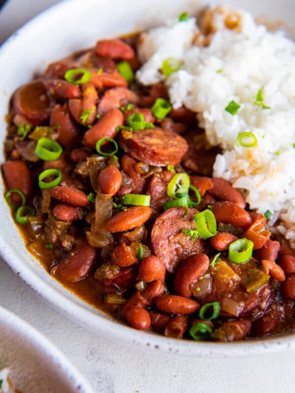 close up of crockpot red beans and rice in a white bowl.