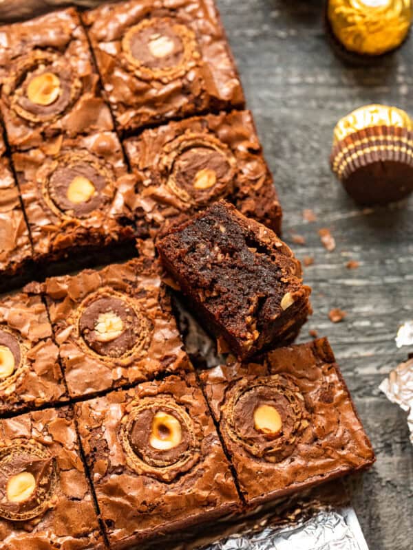 upturned ferrero rocher brownie leaning against cut ferrero rocher brownies.