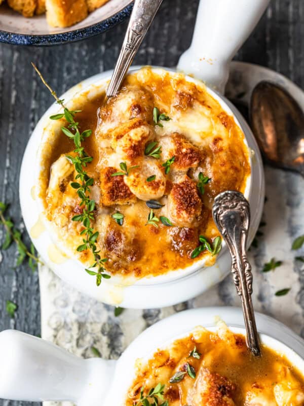 bowls of french onion soup with spoons.