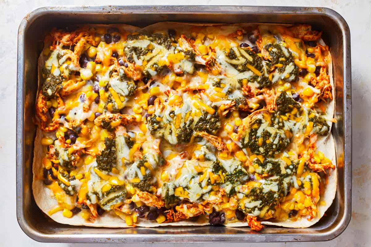 assembling a mexican lasagna in a baking pan