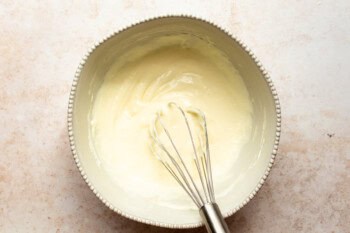 cream cheese mixture in a bowl with a whisk