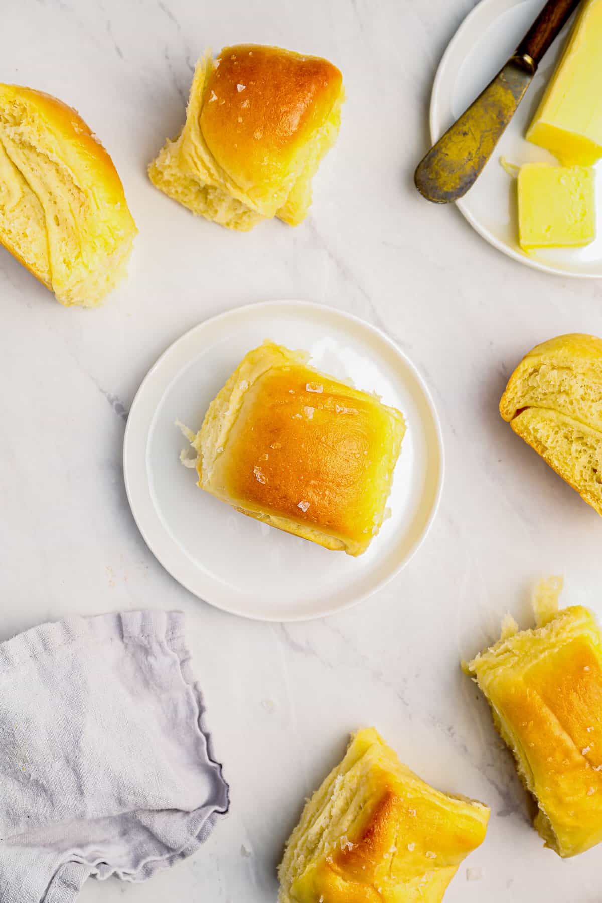 a parker house roll on a white plate.