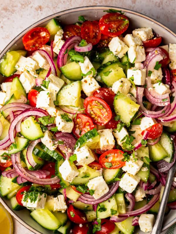 large bowl filled with a colorful cucumber tomato salad