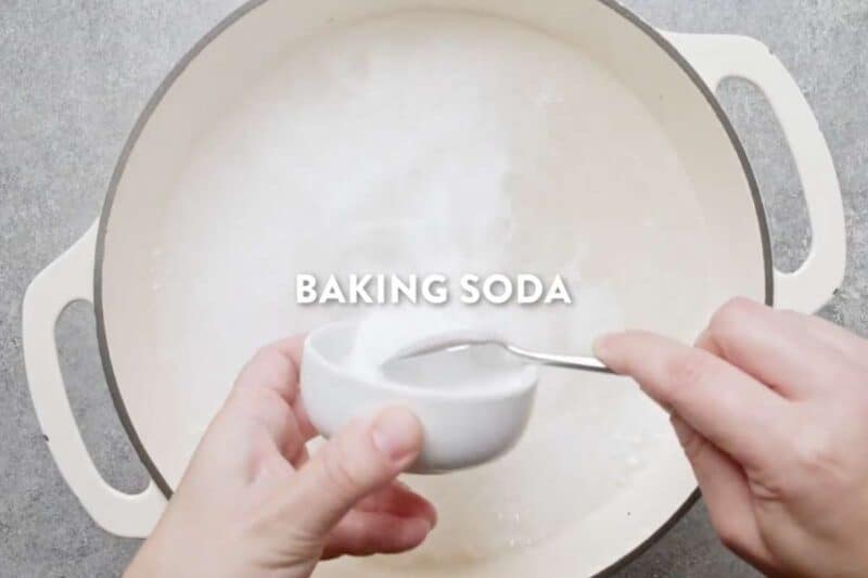 In a large pot combining water and baking soda to make baking soda bath