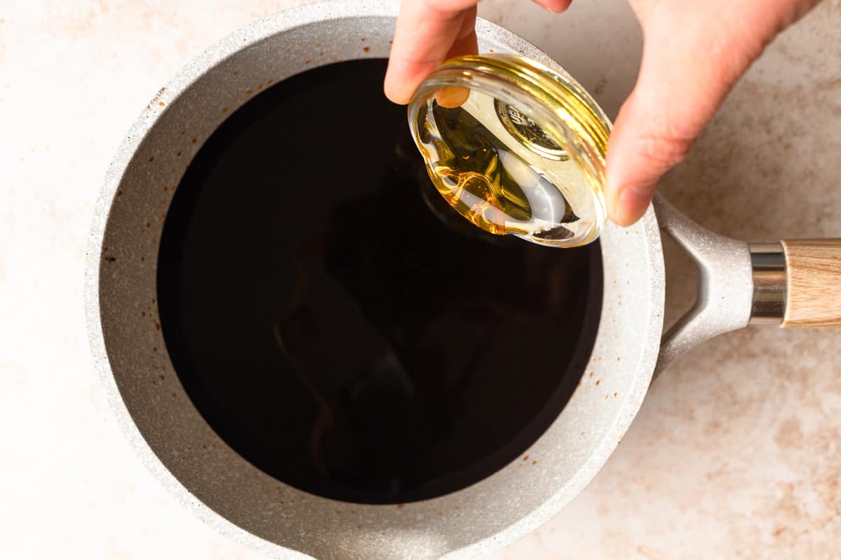 pouring honey into balsamic reduction.