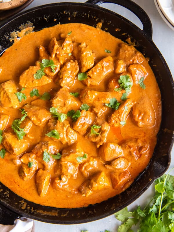 close up of indian butter chicken in a cast iron skillet.