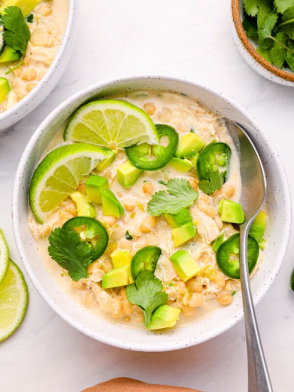 overhead view of instant pot white chicken chili in a white bowl with a spoon.