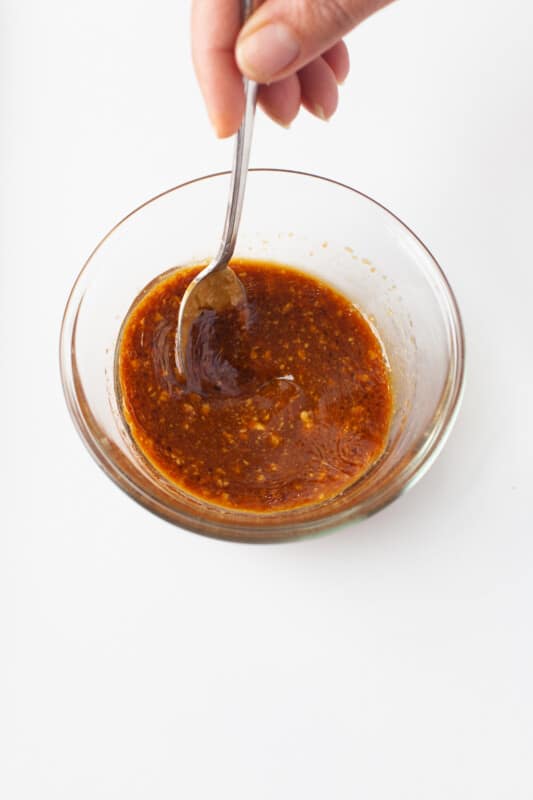 stirring ingredients to make a soy sauce dressing