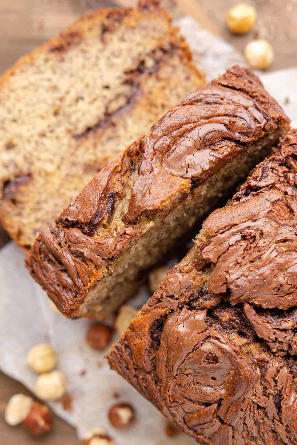 overhead view of sliced nutella banana bread with hazelnuts.