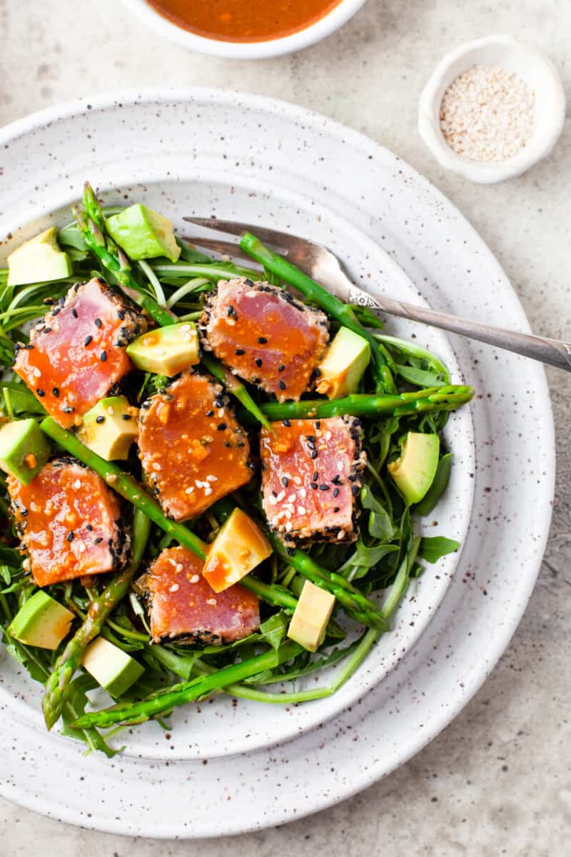 Ahi Tuna with asparagus and avocado, on speckled white dish