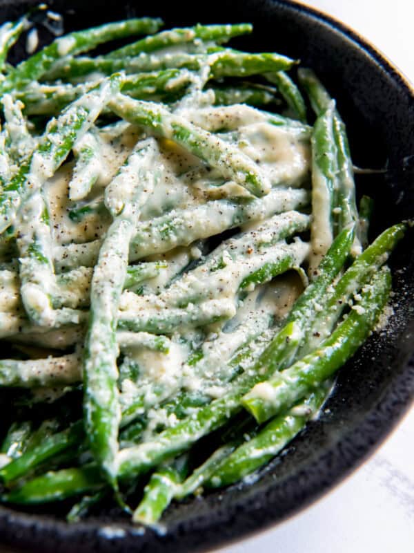 creamed green beans in a cast iron skillet.