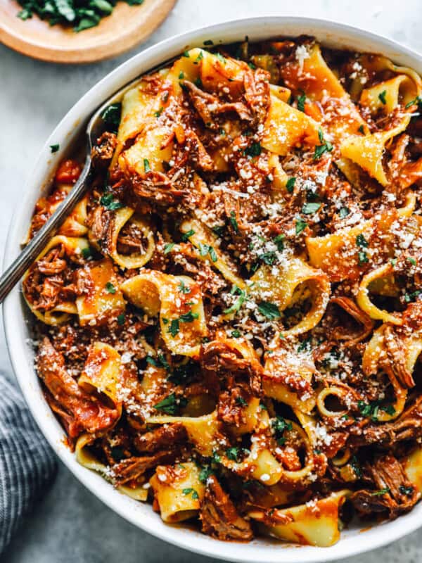 overhead view of slow cooker beef ragu in a white bowl with a fork.