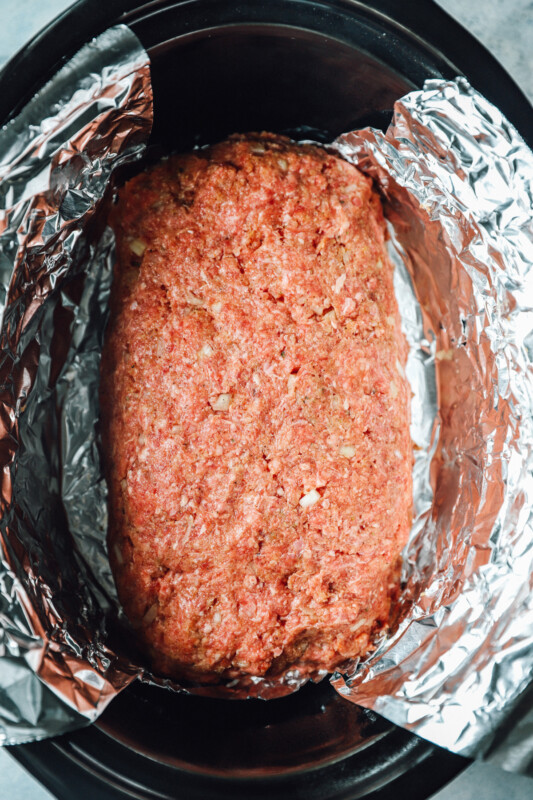 overhead view of uncooked crockpot meatloaf in a crockpot.