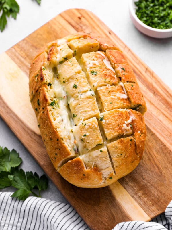 pull apart cheese bread on a wooden cutting board.