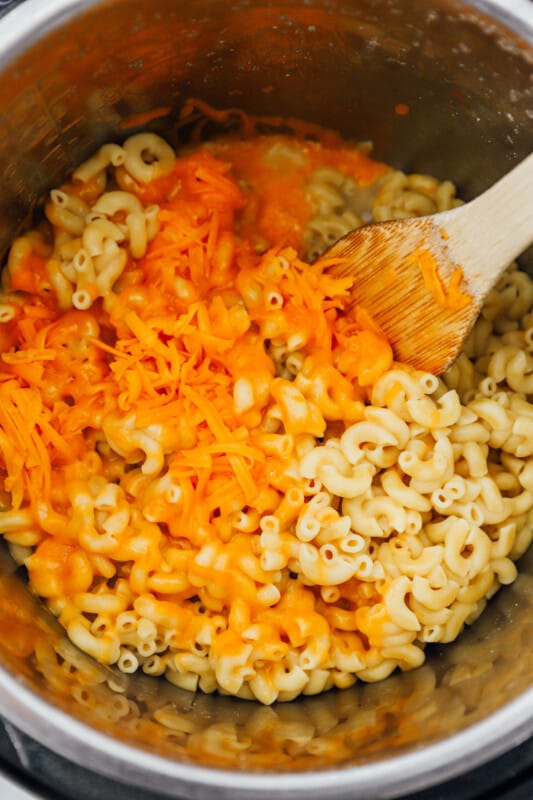 mixing shredded cheese into instant pot macaroni