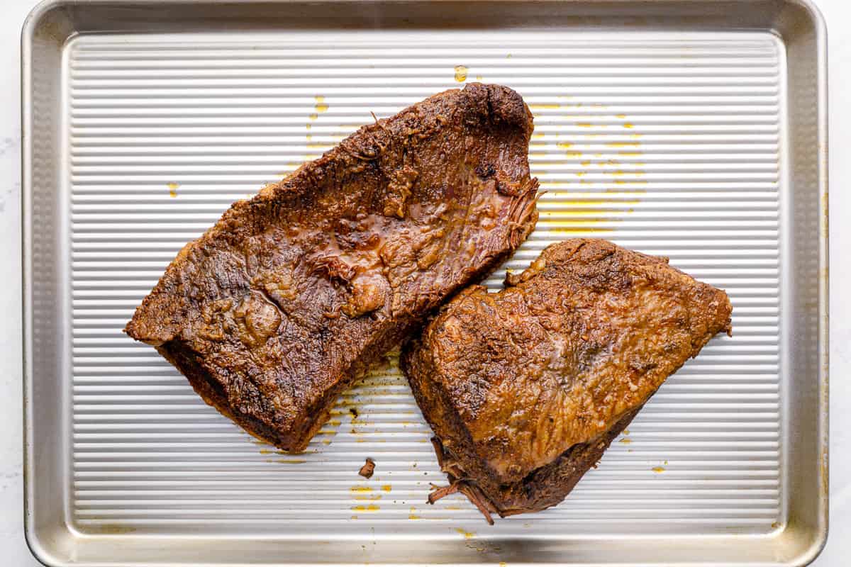 cooked brisket on a baking tray