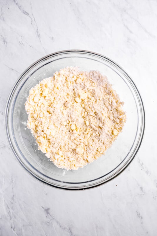 overhead view of dry ingredients for sweet potato pie crust in a glass bowl.