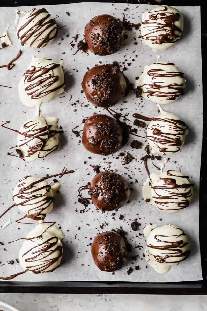 15 oreo truffles on a parchment lined baking sheet.