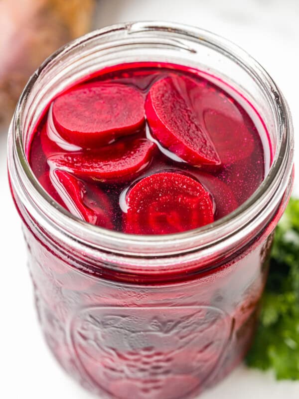 pickled beets in a wide mouth glass jar.