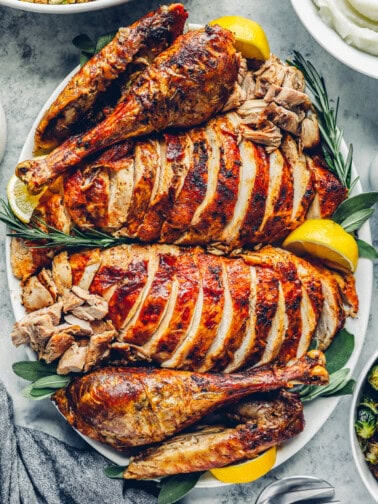 roast thanksgiving turkey, carved and sliced on a serving platter