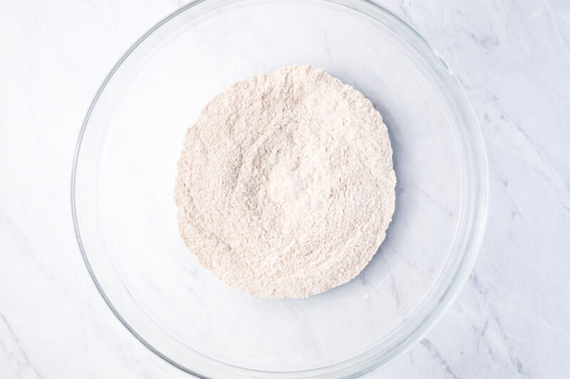 dry ingredients for dog cupcakes in a glass bowl.