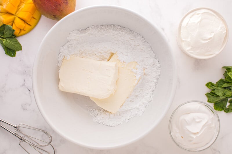 cream cheese and powdered sugar in a white bowl.