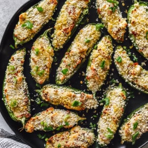 a skillet full of stuffed jalapeño poppers