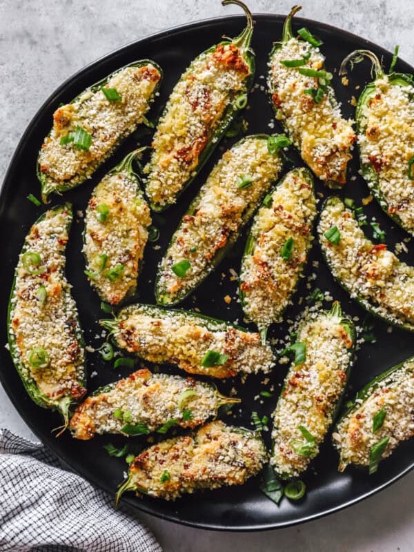 a skillet full of stuffed jalapeño poppers