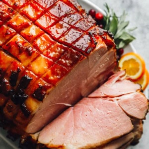 sliced brown sugar glazed ham on a platter.