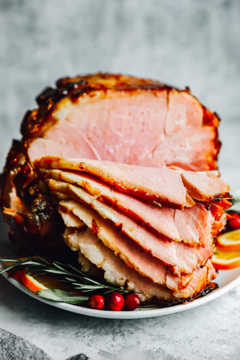 sliced brown sugar glazed ham on a platter.