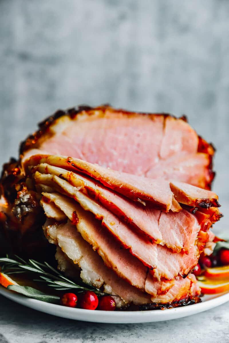 sliced brown sugar glazed ham on a platter.