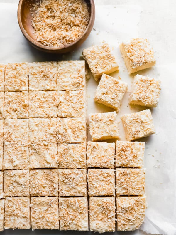 cut coconut fudge on a white table.