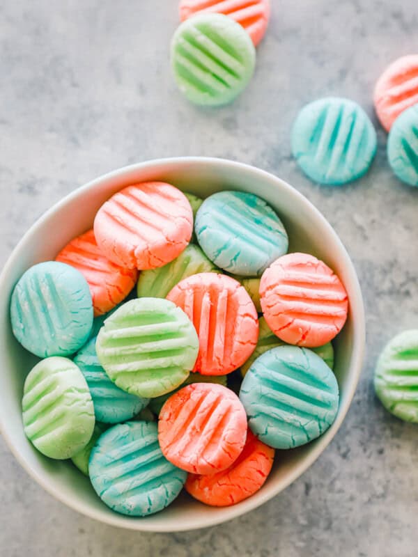 overhead view of cream cheese mints in a white bowl.