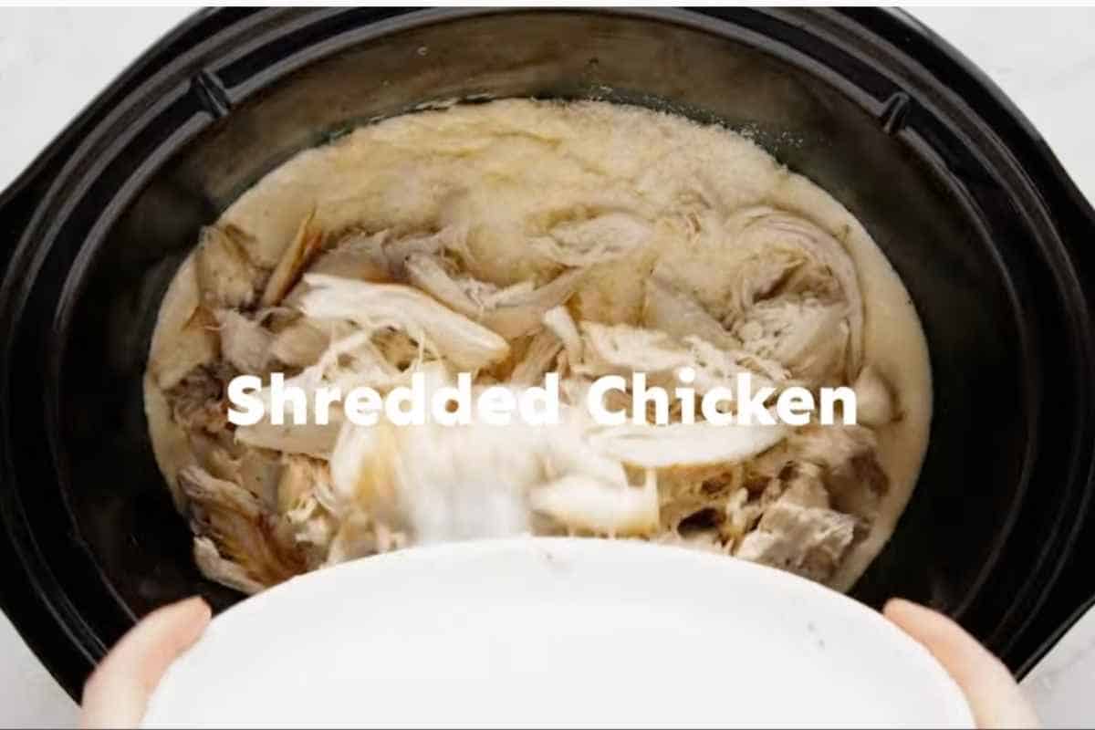 shredded chicken in crockpot and water being added to thin out consistency