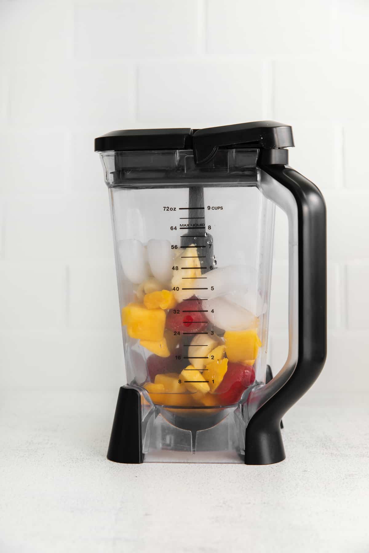 strawberry mango smoothie ingredients in a blender.