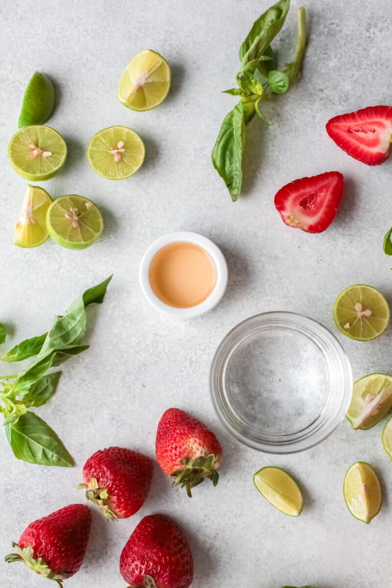 overhead view of ingredients for strawberry basil margarita.