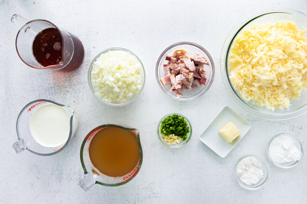 overhead view of ingredients for beer cheese soup in individual bowls.